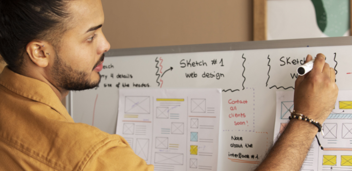 What techniques could scrum masters use? A male scrum master uses the board to present a project plan to his team with help of Easynote.