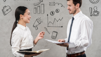 The difference Between Product Management And Portfolio Management is shown as two managers talk to each other in an office