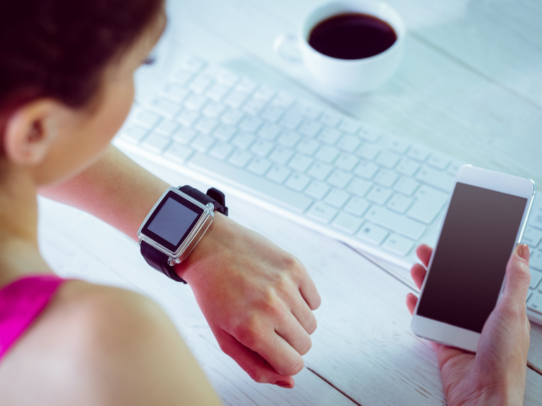 Betst time tracking apps for small business on a wristwatch that girl sees