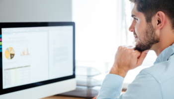 technical debt register template shown on a screen while a young businessman looks at it in his office