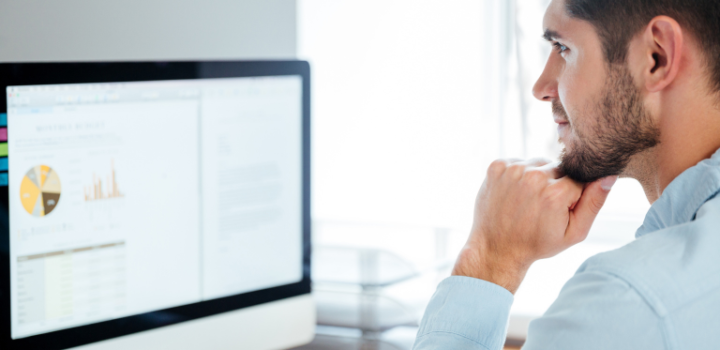 technical debt register template shown on a screen while a young businessman looks at it in his office