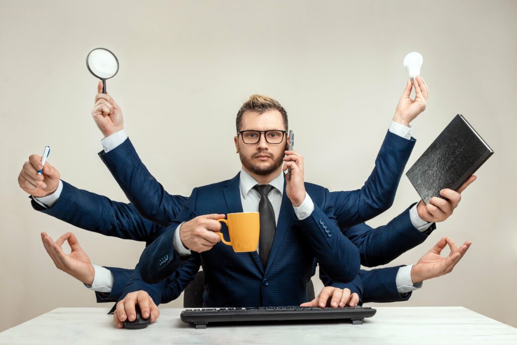  businessman-with-many-hands-suit-works-simultaneously-with-several-objects